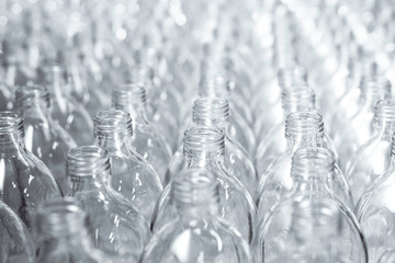 Pattern of transparent glass bottles in a row