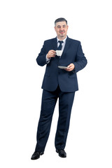 A man in a suit holds a cup and smiles