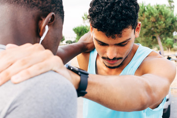 two young men warm up before starting to exercise