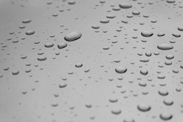 rain drops on blue glass with glare