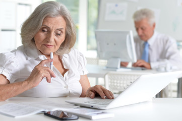 Close up portrait of successful senior businesspeople working together