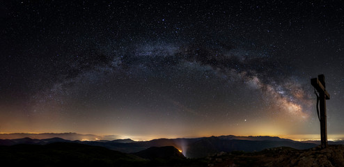 The Heart of Milky Way. View from Mountain with rood on the peak during the night time. Monte...