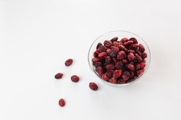 Top view of Dried red cranberry in glass bowl isolated on white background