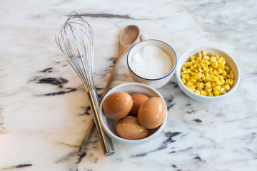 Bowl of corn, eggs and cookware