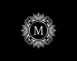 Luxury Silver Badge M Letter Logo. Luxury calligraphic vintage emblem with beautiful classy floral ornament. Vintage Heraldic Frame design Vector illustration.