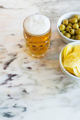 Beer with chips and olives