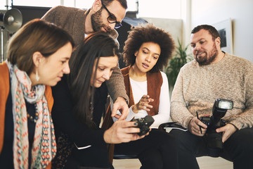 Attendees taking photography lessons form experienced photographer in studio.