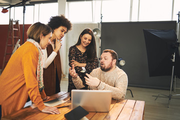 Attendees taking photography lessons form experienced photographer in studio.