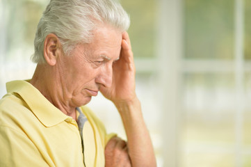 Portrait of thoughtful senior man at home