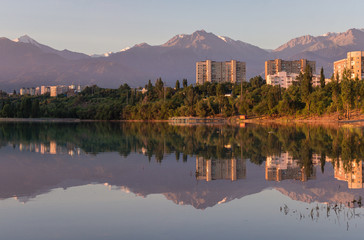 Sayran lake in Almaty city, Kazakhstan, mountains background