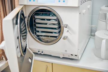 Sterilizing medical instruments in autoclave in medical clinic