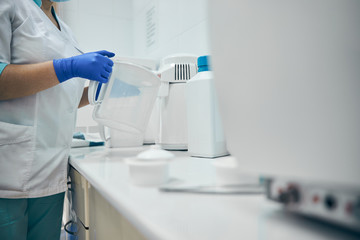 Nurse working at the dentist desk with containers