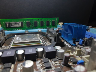Computer Hardware. Motherboard, A close-up microchip with many electrical components placed on the...