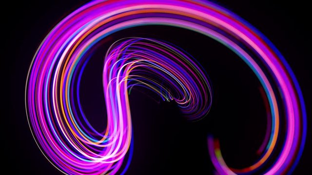 Motion graphics, sci-fi bg. Stream of multicolor neon lines form spiral shape, curls and pattern. Abstract background with light trails, Modern trendy motion design background. Light flow bg in 4k.