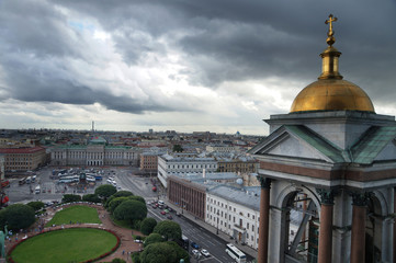 View from the height of St. Isaac's Cathedral in St. Petersburg on a turret with a cross and a dome, and clouds