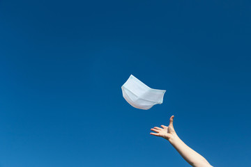 Symbol of the abolition of the obligation to wear a protective face mask. The female hand is...