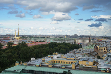 Naklejka premium View from the height of St. Isaac's Cathedral in St. Petersburg on the rooftops and beautiful sights, classical buildings in the distance