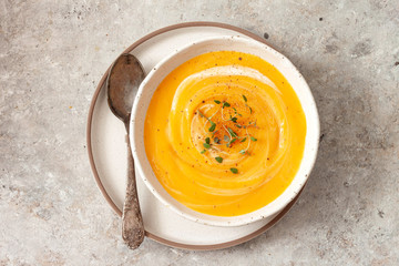 Pumpkin soup with thyme herb, cream and pumpkin seeds.Top view