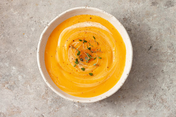 Pumpkin soup with thyme herb, cream and pumpkin seeds.Top view