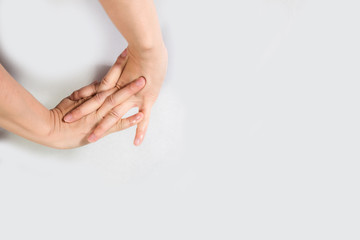 Young beautiful woman has pains in a hand. The hand hurts a woman isolated on white background.