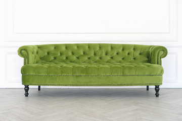 Green sofa on a white wall background
