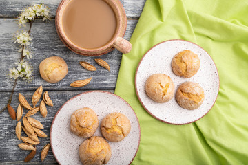 Fototapeta na wymiar Almond cookies and a cup of coffee on a gray wooden background. Top view.