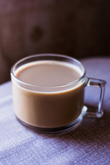 big glass transparent cup of coffee on the table with a tablecloth