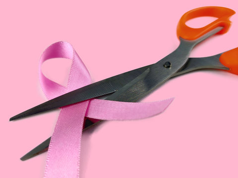 Pink ribbon with Scissors , fight with breast cancer Concept, Selective Focus.