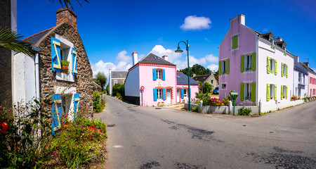 Kervilahouen, a small colourful village on Belle-ile-en-mer, Morbihan, Brittany. A small typical village in France with beautiful houses. - obrazy, fototapety, plakaty