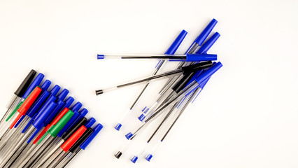 Pile of a lot multi colored plastic ballpoint pens on white background. Abstract stationery background. 16x9 format. Top view. Close-up. - 372298757