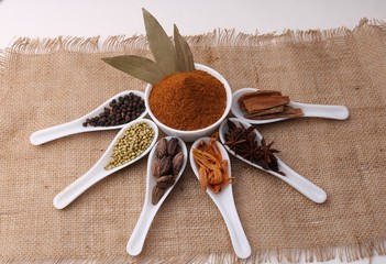 Indian Garam masala powder and colourful spices. Over burlup