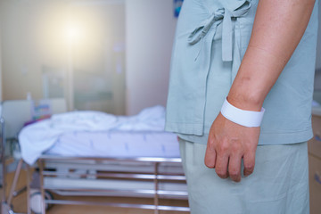 Obraz premium soft focus Patients man quotes in hospital standing by the bed of a ill sick person, patient rests and saline solution tube intravenous iv drip inserted and stand waiting for the doctor to come check.