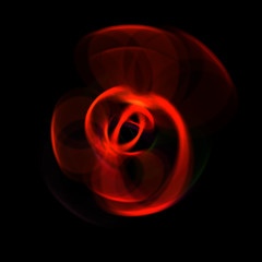 Spinning rays of light isolated on black background. Graphic 2D illustration of glowing colorful light particles in circular motion.