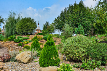 Colorful summer rockery garden at bright sunny day