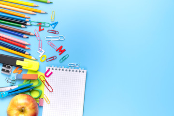 Obraz premium Many different school supplies on blue copy space background. Back to school concept.