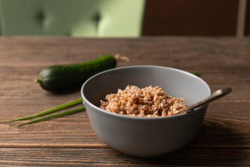 Buckwheat porridge served on wooden table