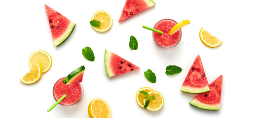 Watermelon, lemon colorful isolated on white background. Fresh red yellow watermelon slices, citrus creative composition, top view. Lemonade in glass, fashionable trendy summer beverage, flat lay