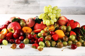 Fresh summer fruits with apple, grapes, berries, plums and healthy apricot.