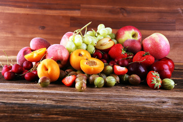 Fresh summer fruits with apple, grapes, berries, plums and healthy apricot.