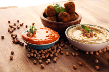 Traditional homemade hummus, falafel and chickpea on rustic table. Jewish Cuisine.