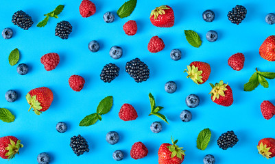 Blueberry, blackberry, raspberry, strawberry colorful pattern on blue background. Fresh blueberry...