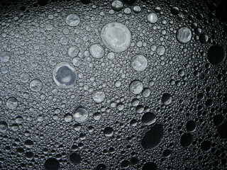 Macro shot of water drops with olia. Lunar landscape.
