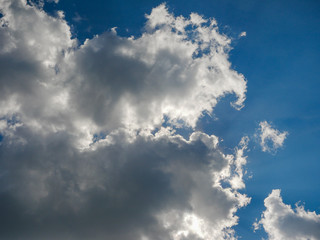 Noyabrsk, Russia - August 9, 2020: The sun's rays are beautifully visible through white clouds against a blue sky.