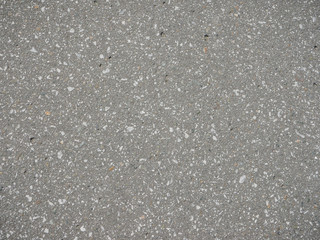Noyabrsk, Russia - August 9, 2020: Background product sample close up open fill concrete slab with texture small pebbles of light colors.