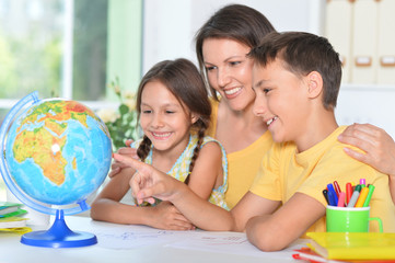 Portrait of happy family looking at globe