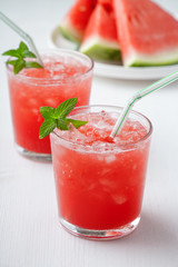 Summer cold drink with watermelon and mint on a wooden background.