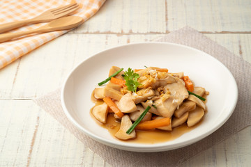 Stir Fried Mushrooms (Pleurotus Eryngii (King Oyster Mushroom)) with Oyster Sauce on white plate.