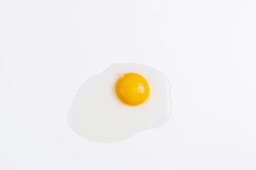 A broken raw chicken egg on a white background without a shell. The ingredients for the omelet. Farm eggs. Eggs are light in color. The lack of food.