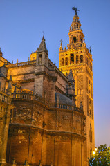 Fototapeta na wymiar Sunset and first artificial lights in the Cathedral of Seville