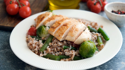 Grilled chicken breast with buckwheat porridge and vegetables. Healthy balanced meal